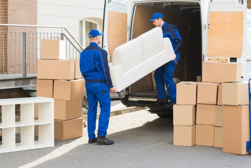 Man and van removal team loading furniture in Merton