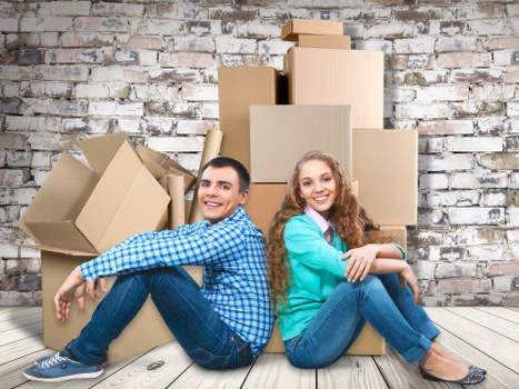 Trained movers handling furniture safely with gloves and equipment