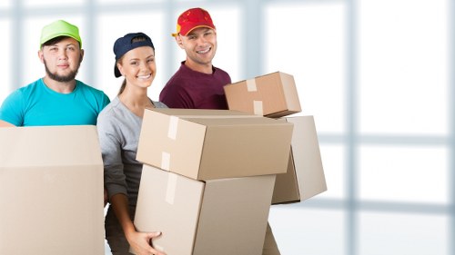 Movers unloading household items at a new property in Merton