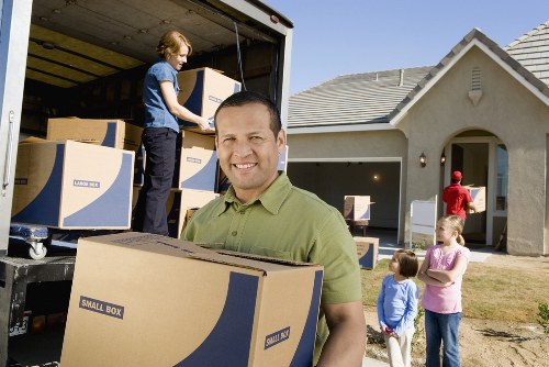 Loading furniture into a moving truck in Merton