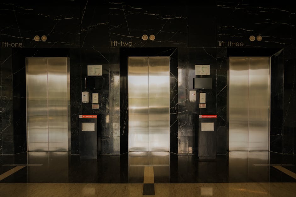 A metallic escalator with black steps and silver handrails ascending inside a building, illuminated by overhead lighting. The surrounding walls are paneled in light-colored wood or laminate, and the environment appears clean and modern, typical of indoor public or residential access points. The escalator is part of a home relocation process, possibly used to facilitate moving furniture or boxes between floors. There are no additional objects or people visible in the image. This setting aligns with essentials of moving and access planning, which Removal Companies Merton offers as part of their professional removals services for flats, such as those in Morden SM4, ensuring smooth elevator moves and related logistics.